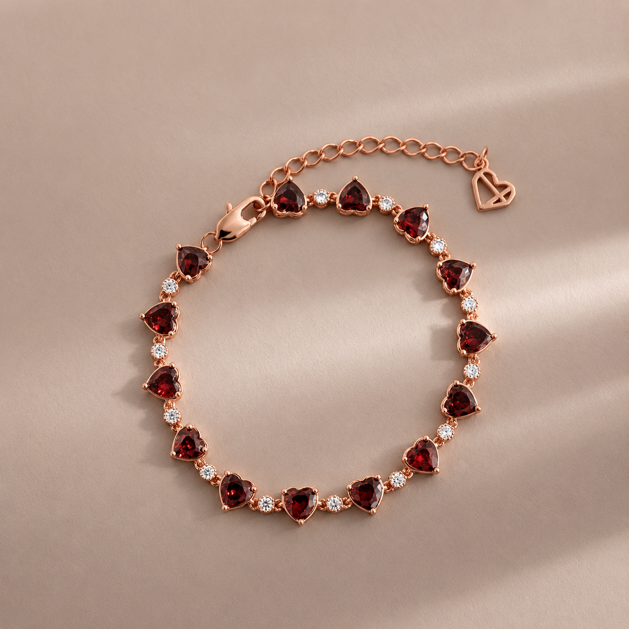 Rose gold bracelet with heart-shaped gemstones on a beige background
